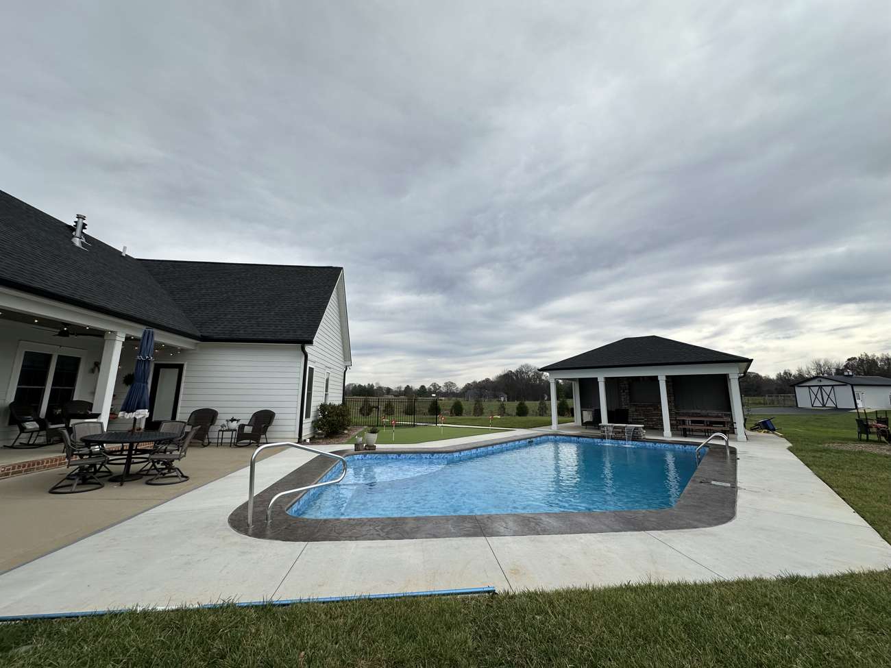 Pool, gazebo, and stamped concrete patio built by Buck Nekkid Outdoor Living