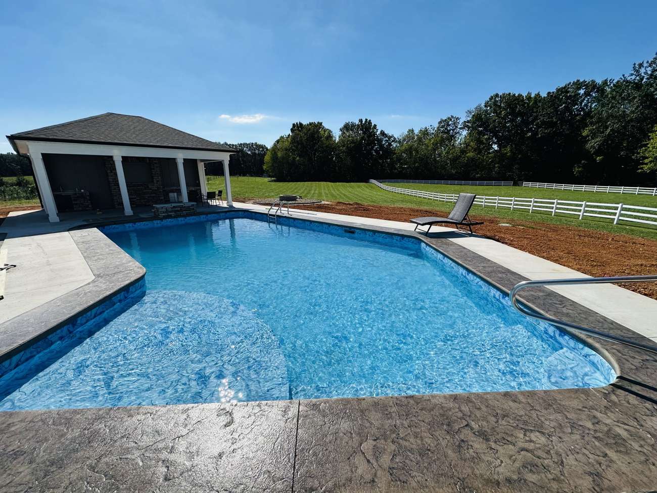 Freeform pool with a matching pool house